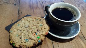 Hot cup of coffee and monster cookie for your dining pleasure