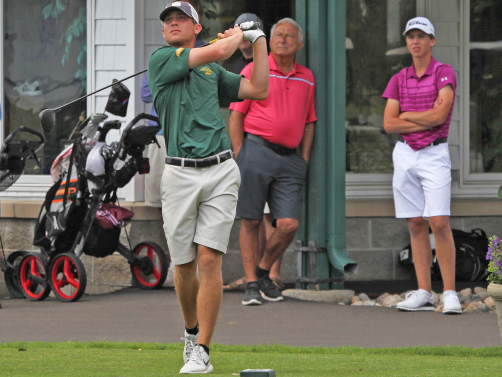 Golfer watches the ball after swinging