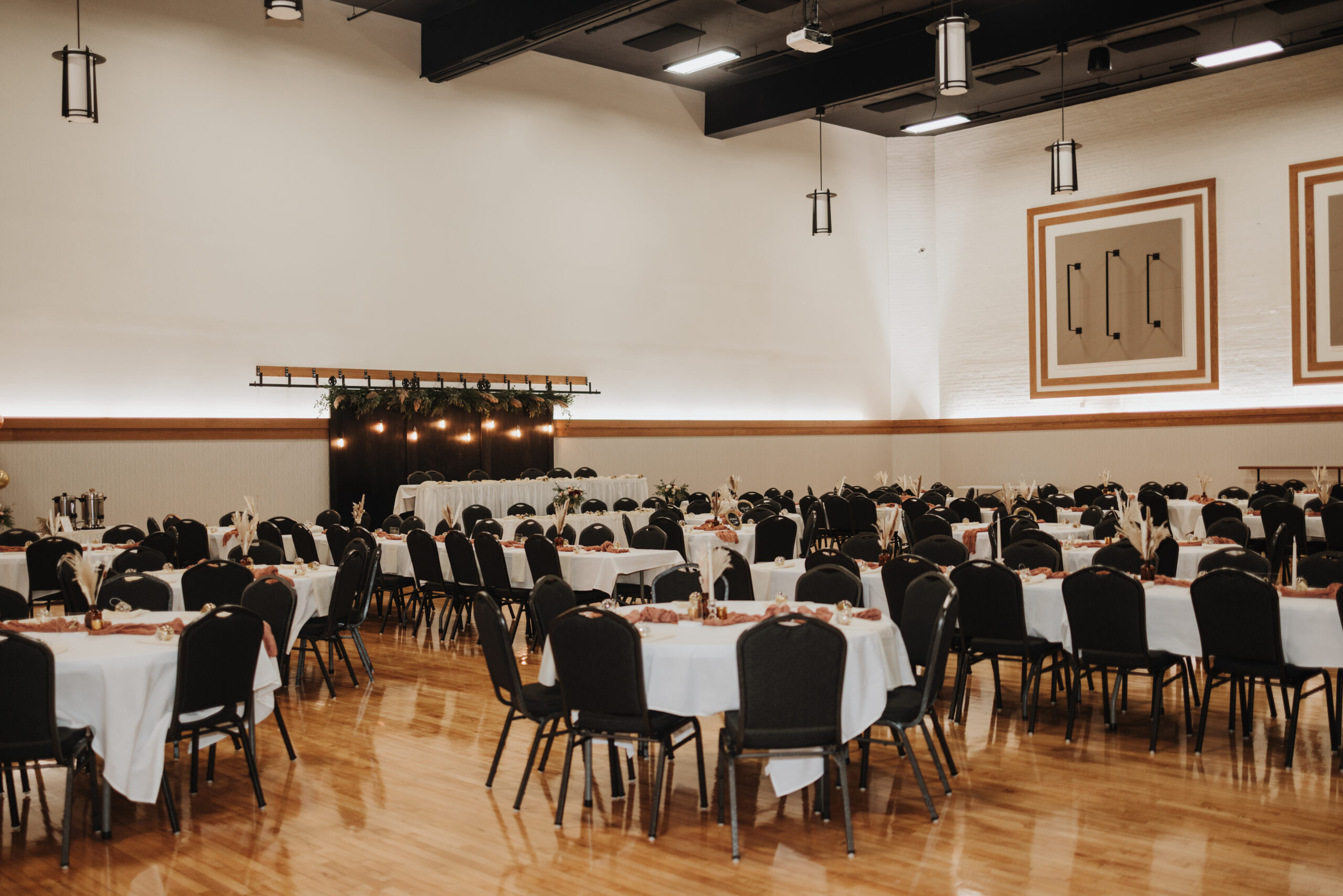 White linens on round tables in the Historic Holmes Theatre Ballroom