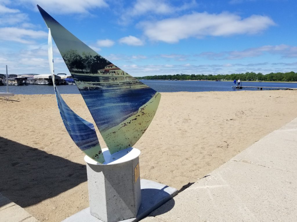 Sailboat sculpture on beach by Little Detroit Lake