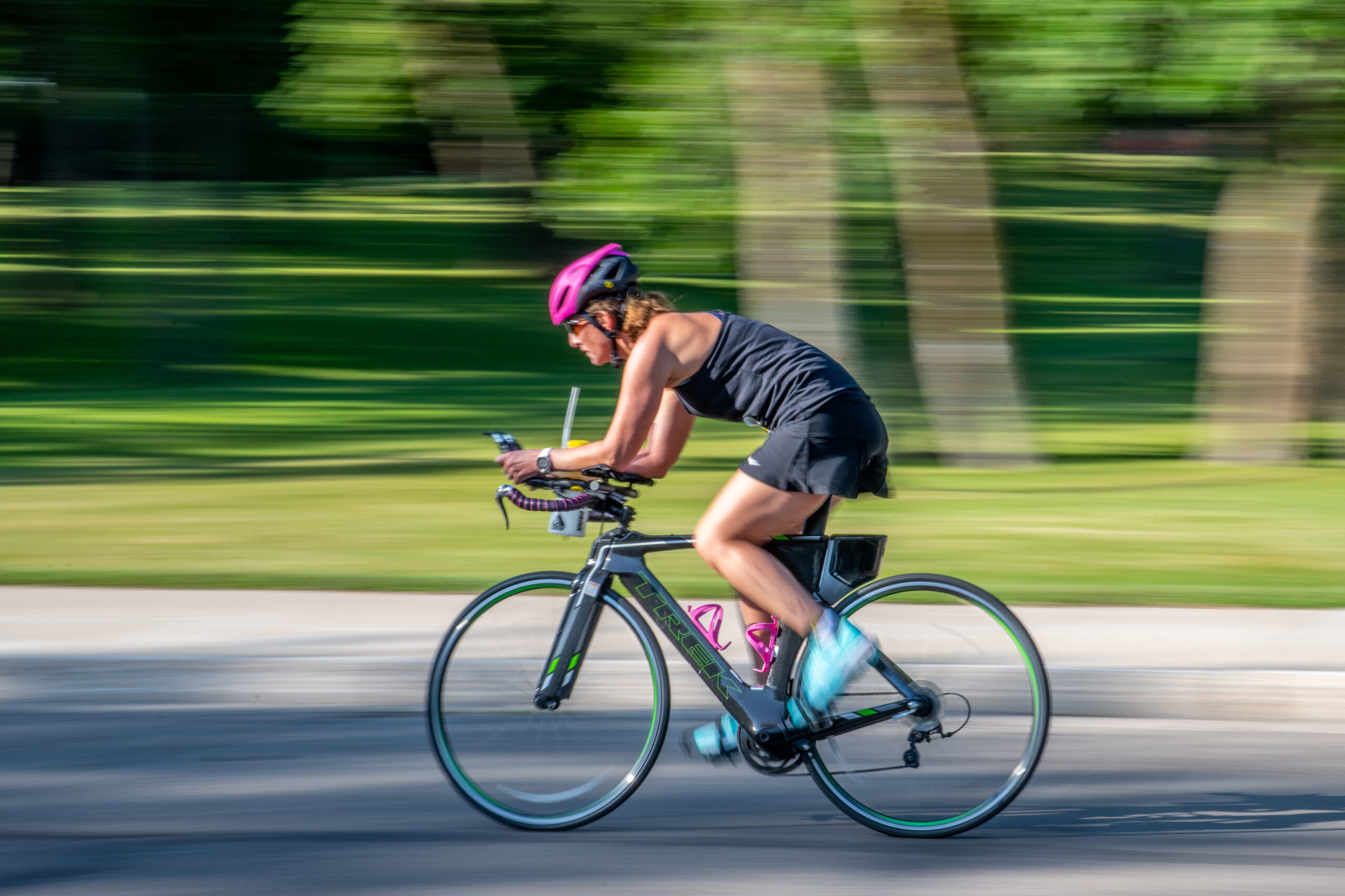A triathlon competitor speeds by on a bike