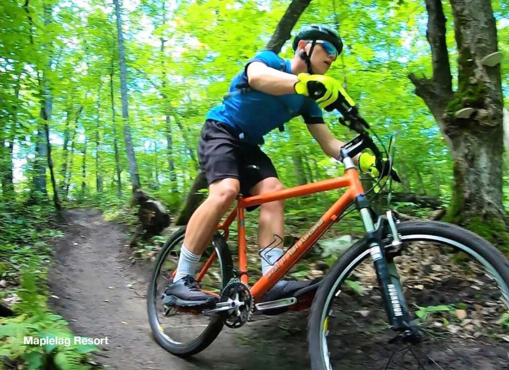 Man riding mountain bike on wooded trails