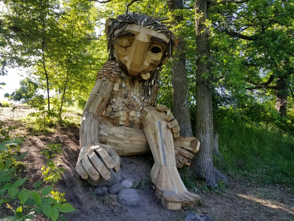 Barefoot Frida reclines by a hardwood tree 