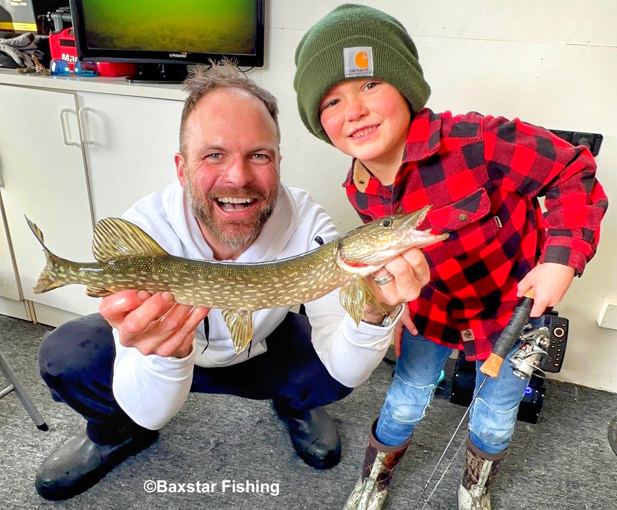 Fishing guide with big smile holding fish a young boy caught