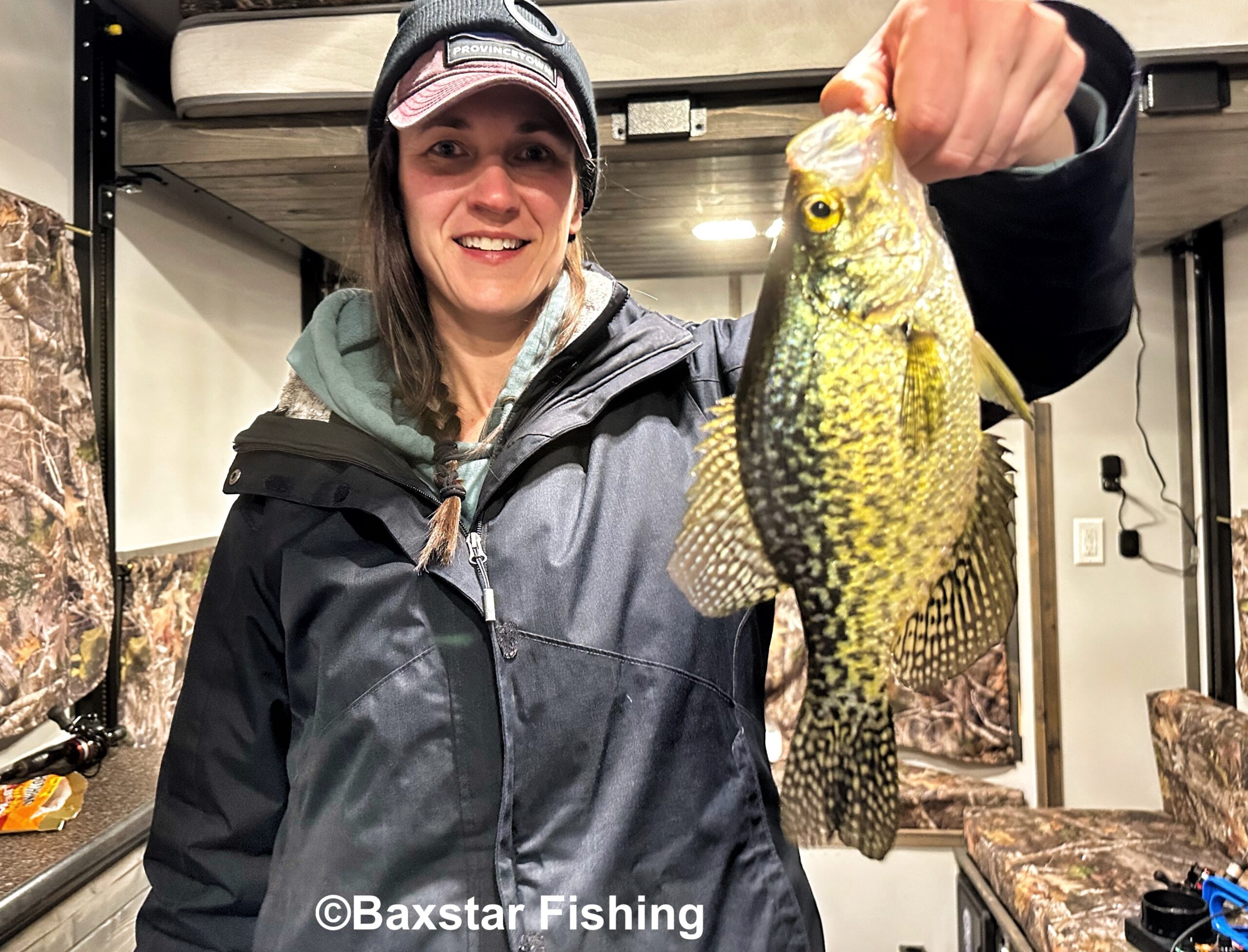 Lady holding a nice crappie caught ice fishing