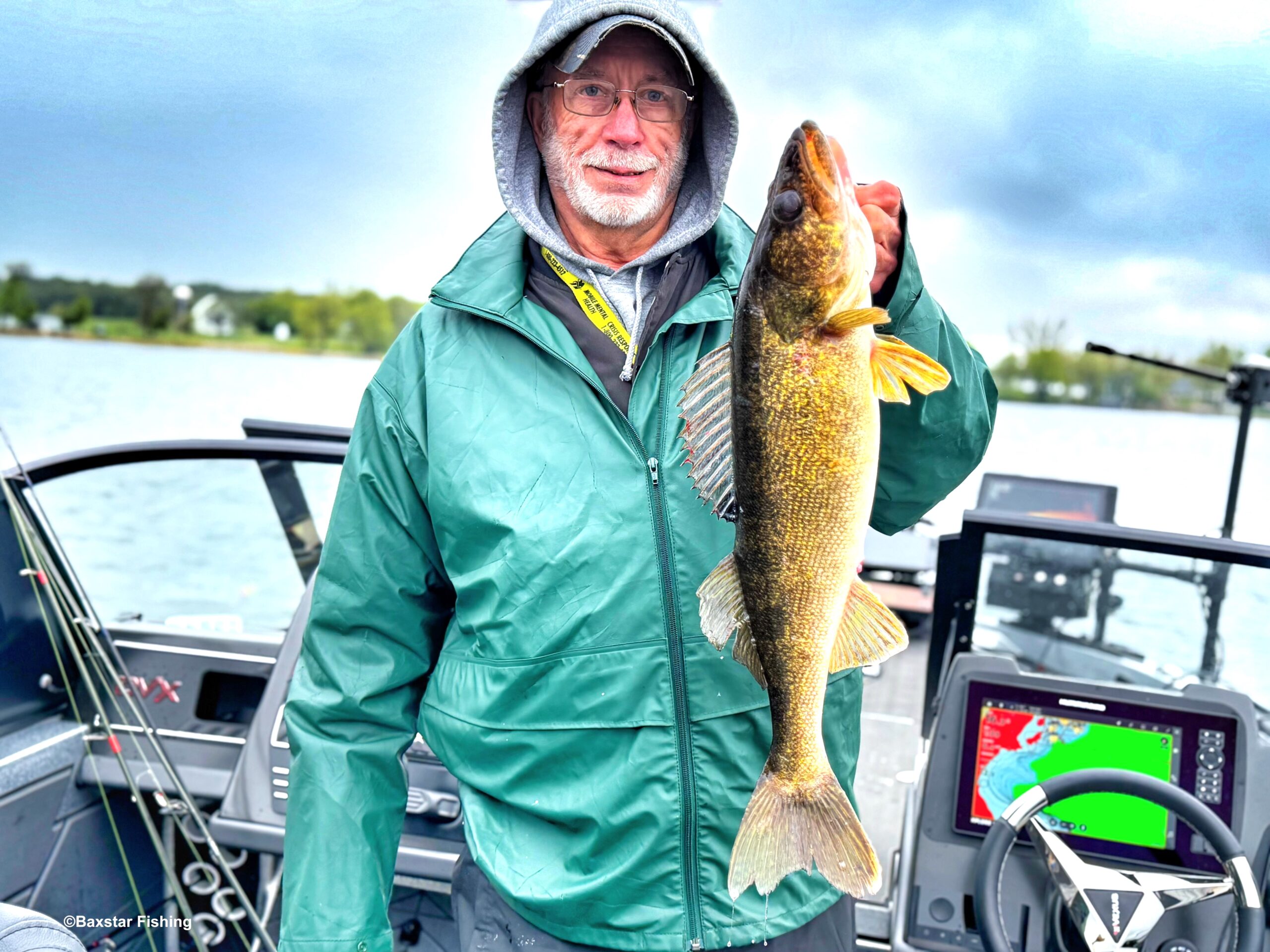 man holding a nice walleye caught in boat on lake